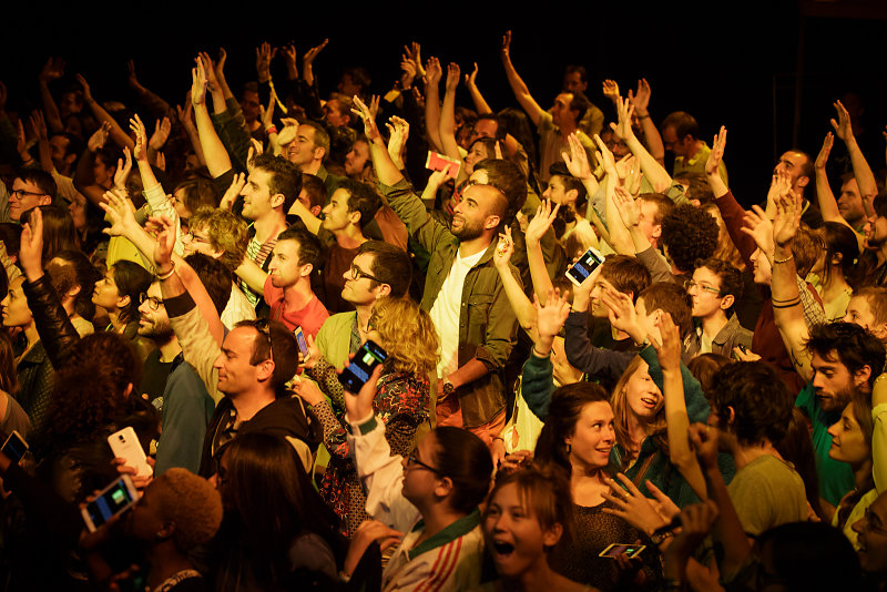 Audience in the yellow space playing during the show